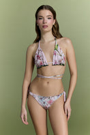 Nur Karaata Sunset Palms bikini featuring tropical palm leaf print and vibrant colors, displayed on a model.