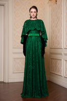 Green A-line gown with a mullet cape from I.H.F, featuring elegant flowing fabric and a stylish, layered design.