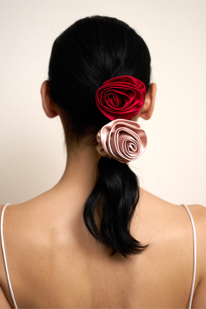 Cream-colored silk scrunchies from Not Just Pajama, designed as elegant hair accessories with a smooth, luxurious finish.