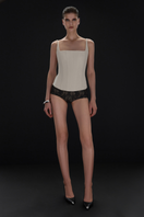 Beige matte silk corset top with straps from BALYKINA, showing the fitted design and smooth fabric texture.