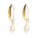 Hammered gold Baroque pearl earrings by Freya Rose featuring large irregular pearl drops and textured gold hooks.