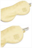 Butter yellow silk eye mask from Not Just Pajama, soft loungewear accessory for relaxing and sleep.