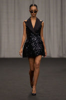 Lili Blanc sleeveless sequin mini dress with a fitted silhouette and shimmering gold sequins, perfect for evening wear.