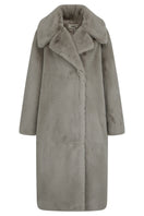 Brown oversized shearling coat by JINSUN featuring plush shearling material and a relaxed fit, shown on a model.