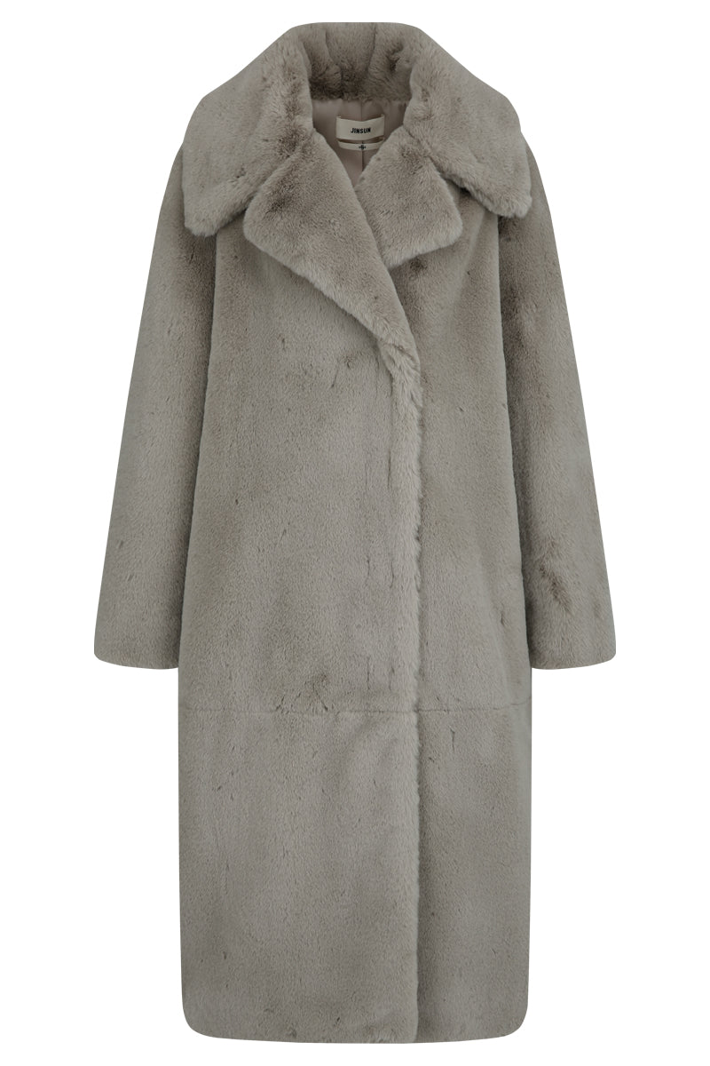 Brown oversized shearling coat by JINSUN featuring plush shearling material and a relaxed fit, shown on a model.