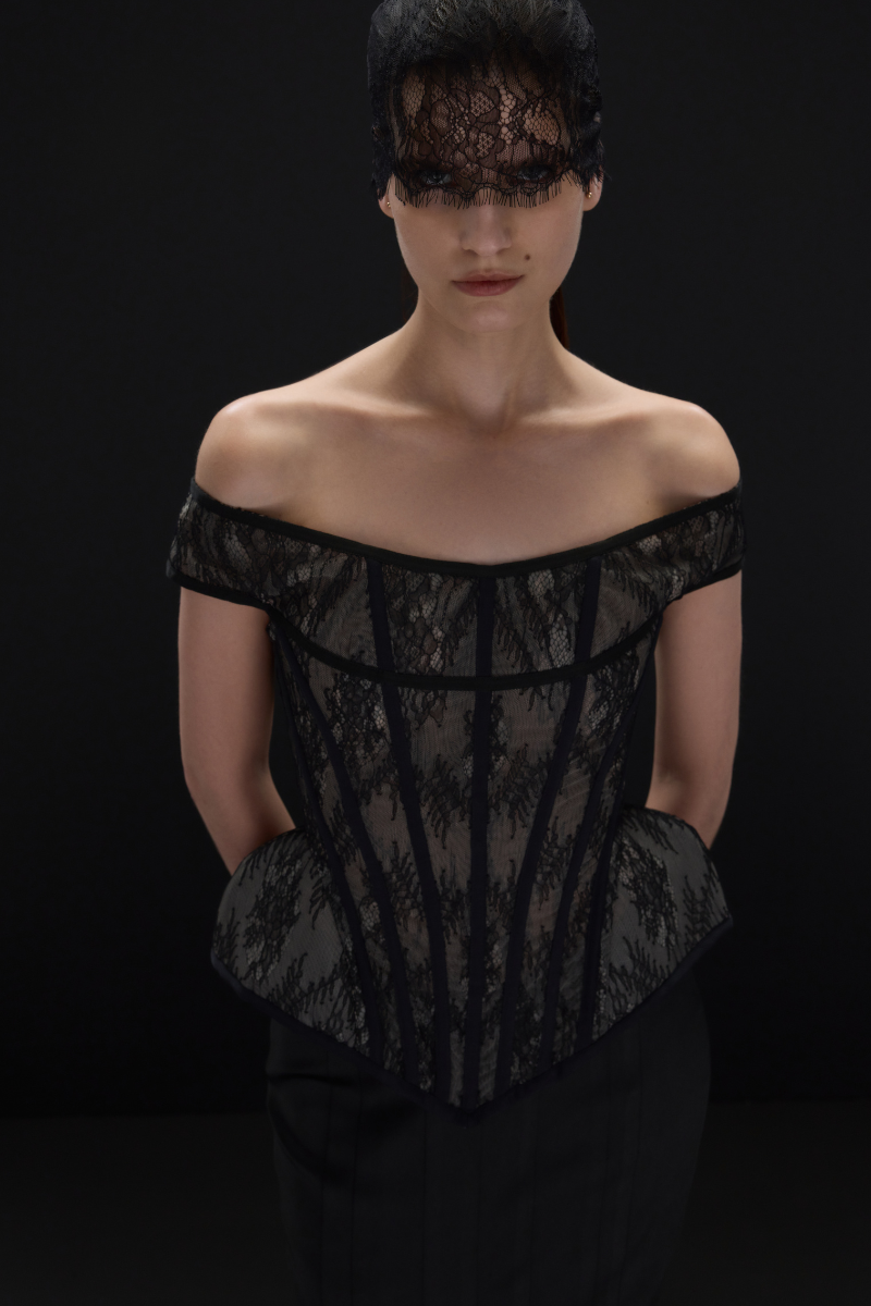 Black lace corset top by Balykina featuring intricate lace details and fitted design, perfect for stylish evening wear.