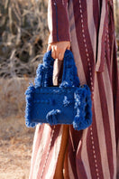 Navy blue Bani MINI POKA top handle bag with a sleek design and structured handle, perfect for casual or formal wear.