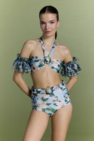 Nur Karaata Coconut Coastline Bikini shown on a model, featuring a stylish tropical print and adjustable straps.
