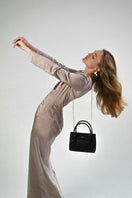 Black CELINE mini top handle bag from VIKELE STUDIO with a structured design and top handle for elegant carry.