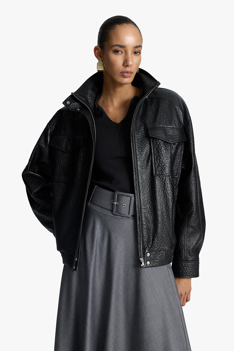Acaria Studio Zoe leather bomber jacket displayed on a hanger, featuring a classic design with ribbed cuffs and collar.