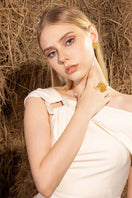 Elegant mushroom crystal long gown by Do Long featuring intricate detailing and flowing fabric.