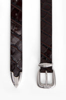 Maroon crocodile-embossed leather belt from Acaria Studio Victory collection, featuring a sleek design and silver buckle.