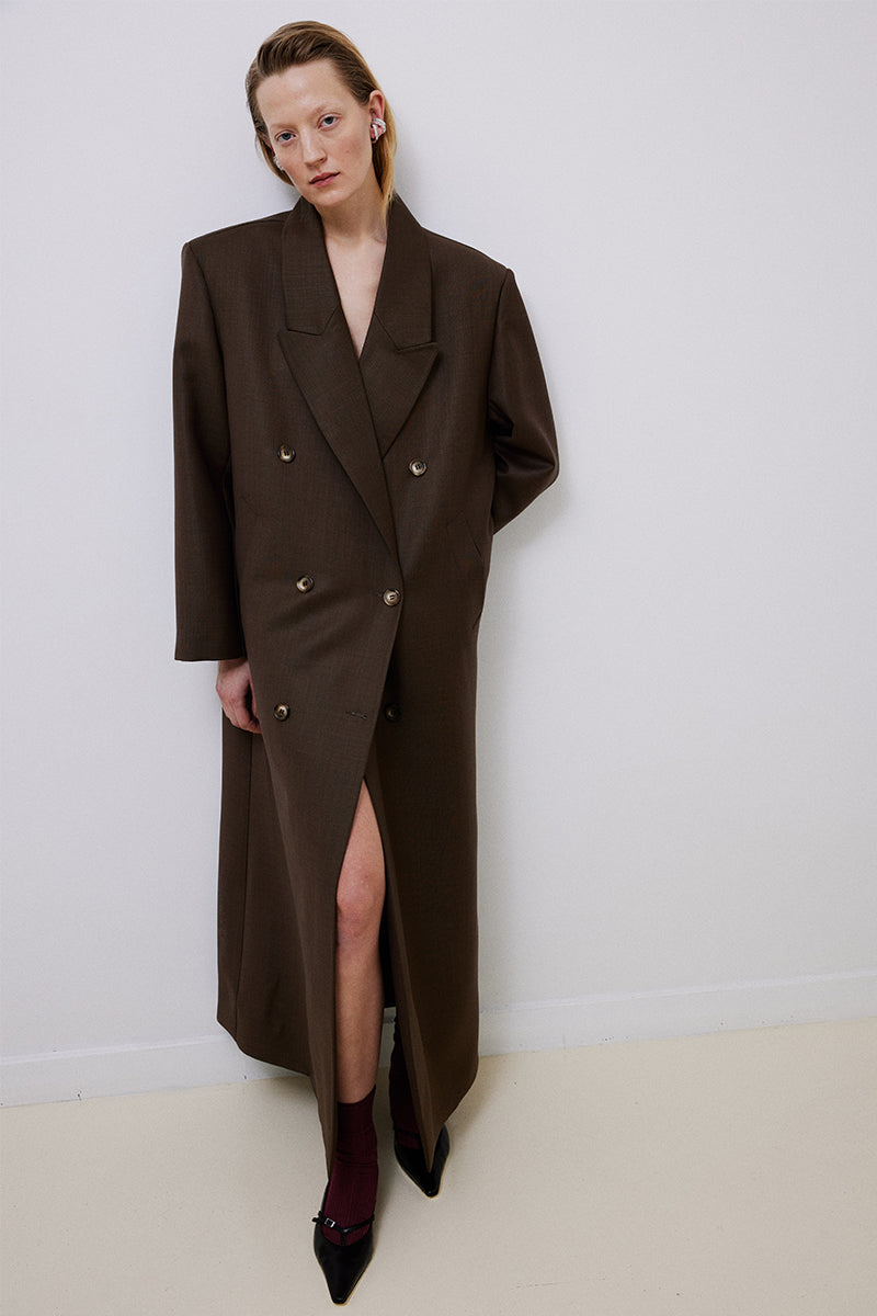 Brown oversized double-breasted wool coat by TAGG, featuring a classic design with wide lapels and a relaxed fit.