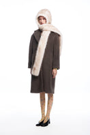 Chictopia faux fur hood scarf draped over a model’s shoulders, showcasing soft, plush faux fur material and stylish hood design.
