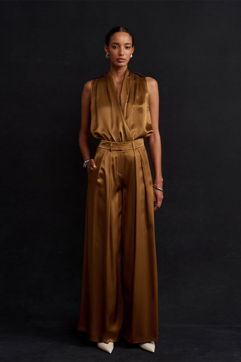 Acaria Studio Jill satin pants in copper, showcasing the smooth fabric and stylish tapered fit on a model.