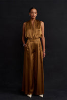 Acaria Studio Jill satin pants in copper color, featuring a smooth, shiny fabric and tailored fit, displayed on a neutral background.