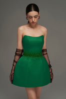 Dark green I.H.F Studio bustier mini dress displayed on a hanger, highlighting its fitted design and stylish neckline.