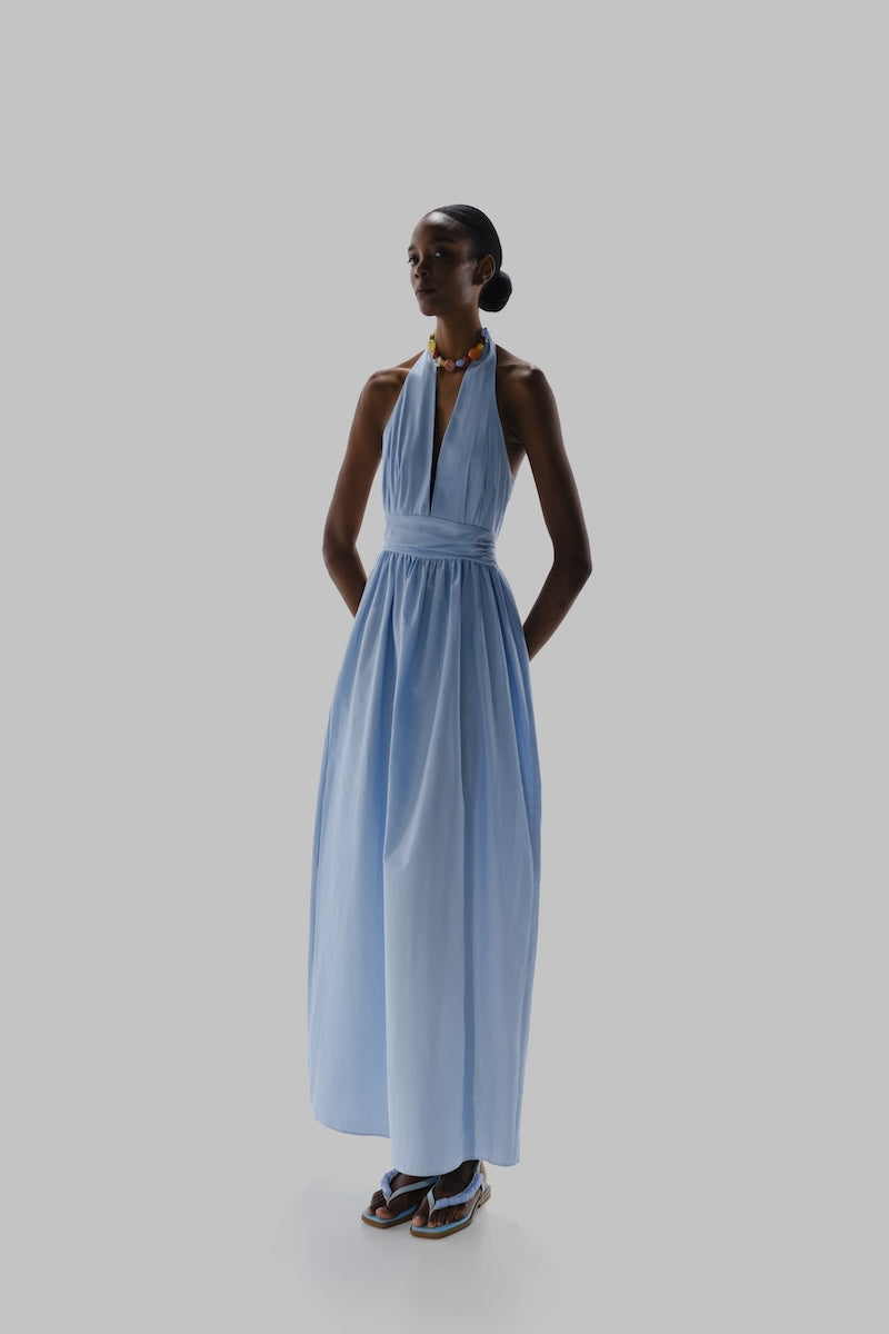Baobab Agustina maxi dress in vibrant blue fabric, flowing design with elegant straps, perfect for summer occasions.