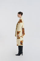 Side view of JINSUN printed wool silk jacket in pale yellow, showcasing lightweight fabric and stylish design.