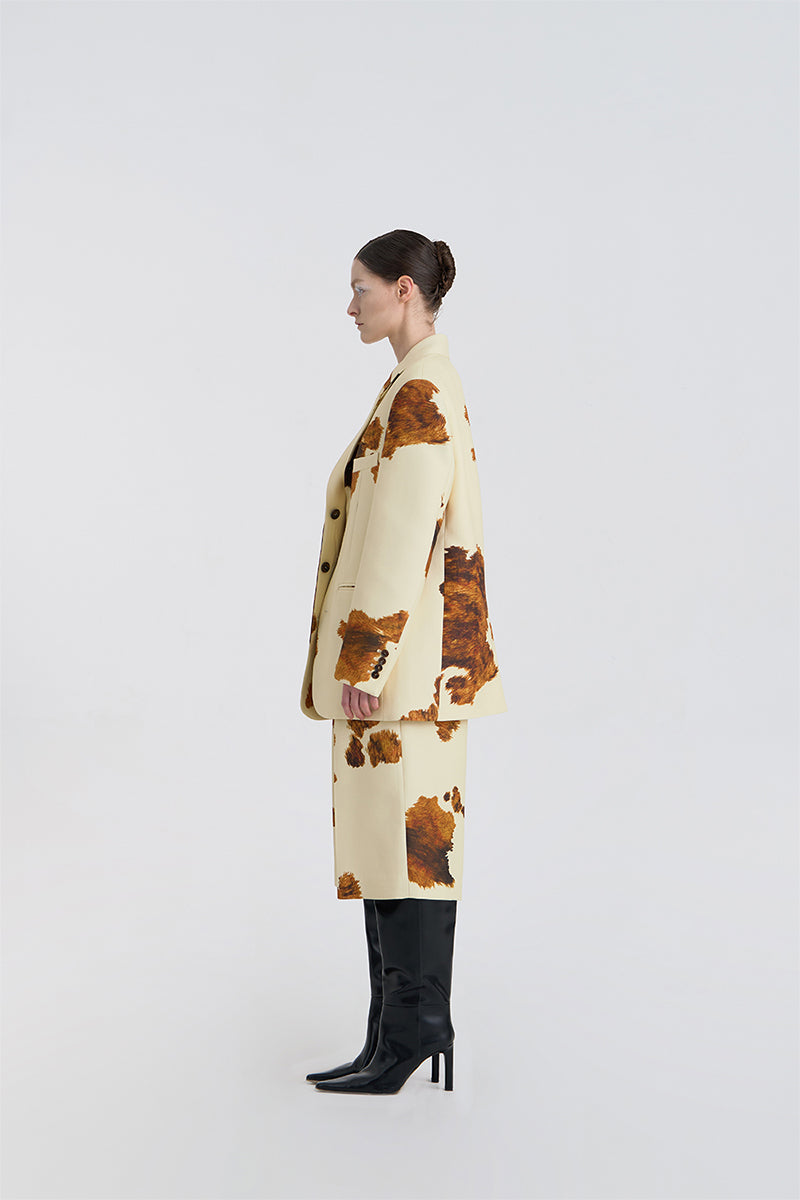 Side view of JINSUN printed wool silk jacket in pale yellow, showcasing lightweight fabric and stylish design.
