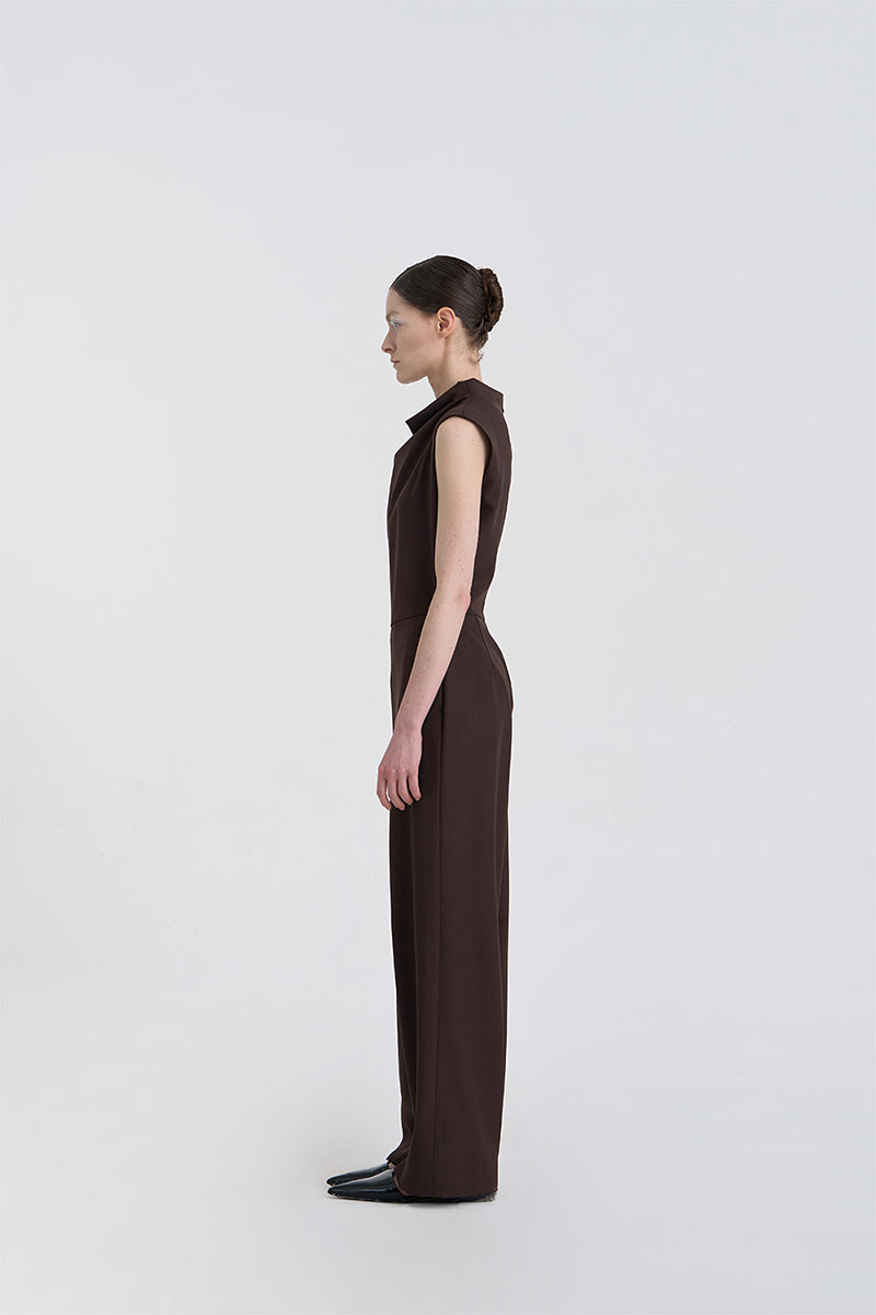 JINSUN FILANTE wool brown jumpsuit shown from the side, featuring long sleeves and a relaxed fit for casual or office wear.