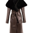 Brown leather trench coat with fur collar by Kris Marán, featuring classic design and stylish details in the image.