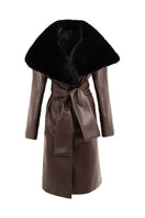 Brown leather trench coat with fur collar by Kris Marán, featuring classic design and stylish details in the image.