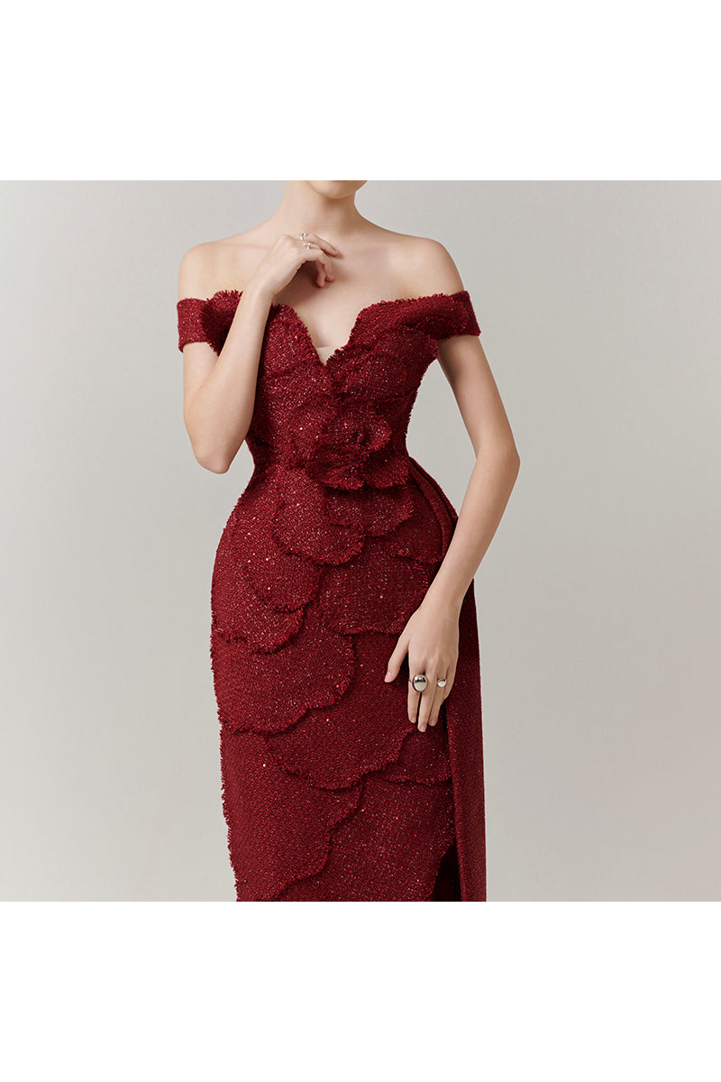 Red off-shoulder tweed maxi gown by Happy Clothing featuring petal details, elegant design, and a flowy silhouette.