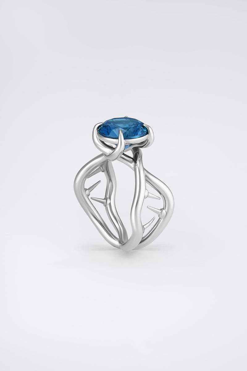 Silver Thorn Ring by Poché featuring a delicate, spiked design, displayed on a neutral background.