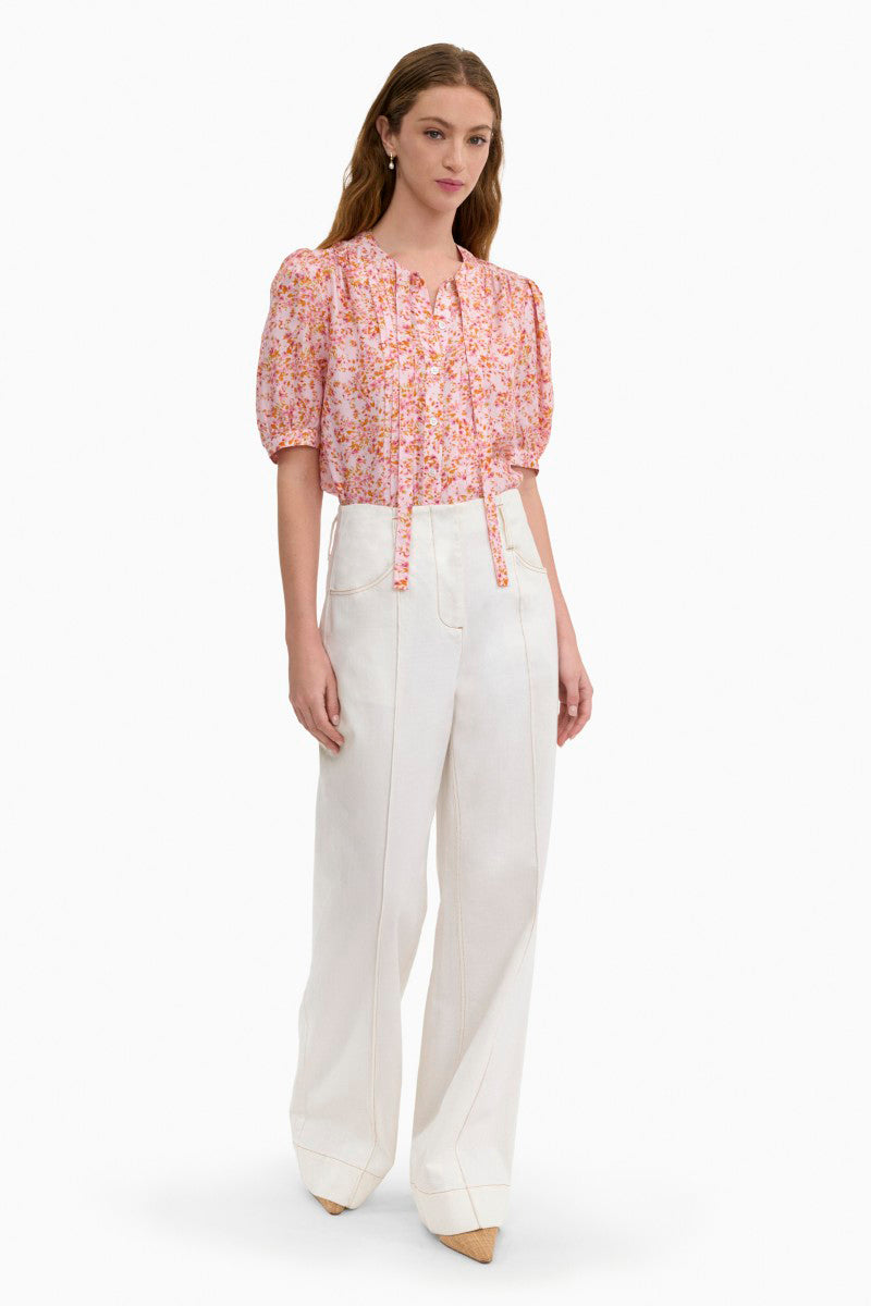 Rebecca Taylor Bellamy silk blouse in pale pink with multi-colored accents, shown on a hanger.