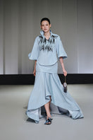 Jenny K Tran Colchester Top, stylish women's blouse with a relaxed fit and detailed neckline, shown on a hanger.