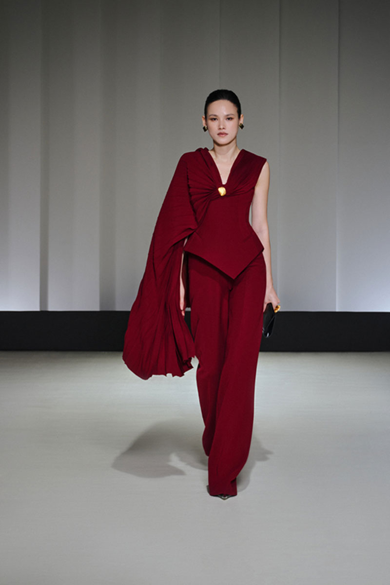 Jenny K Tran Adlington top displayed on a hanger, showcasing its stylish design and fabric details.