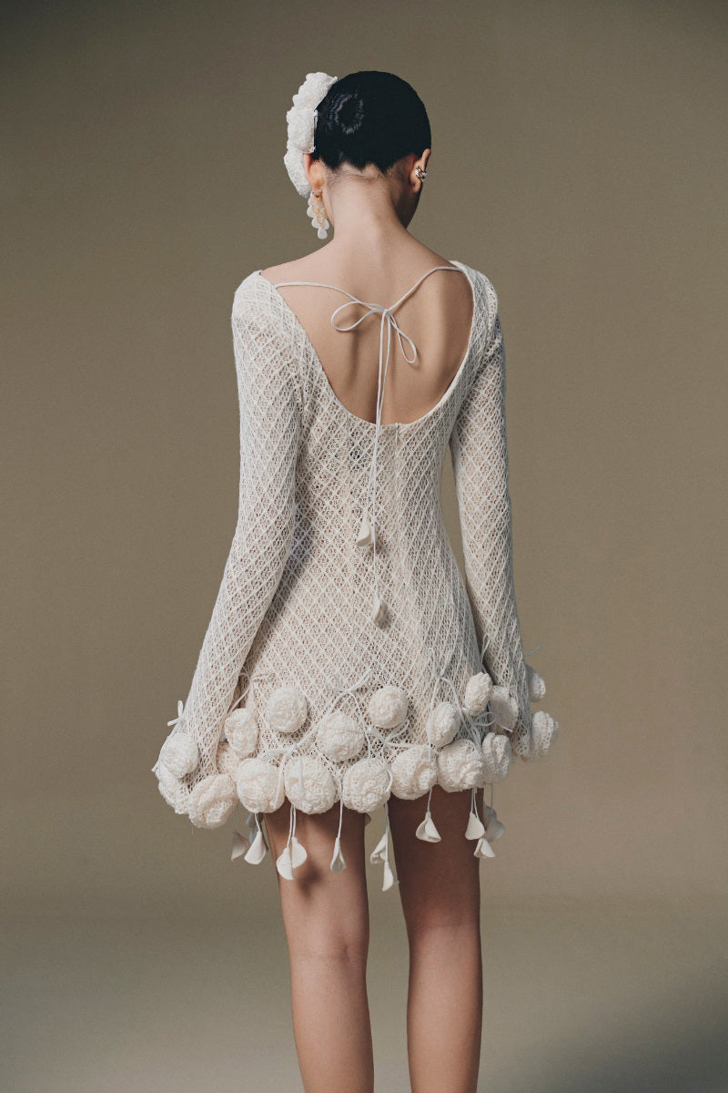 Keira Tong sculpted rose mini dress featuring fitted design, floral rose pattern, and sleeveless style on model.