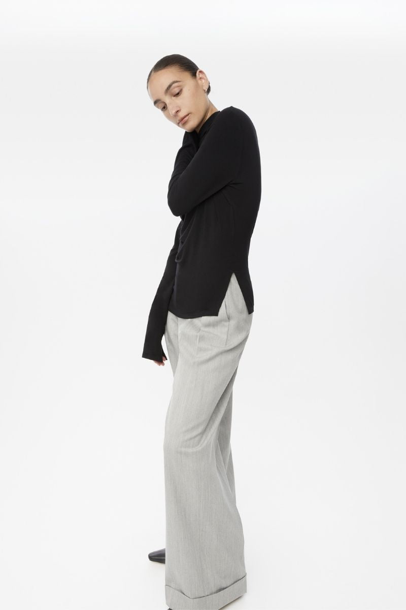 Dāl the Label modal asymmetric knit top featuring a stylish, modern design with a relaxed fit and textured fabric.