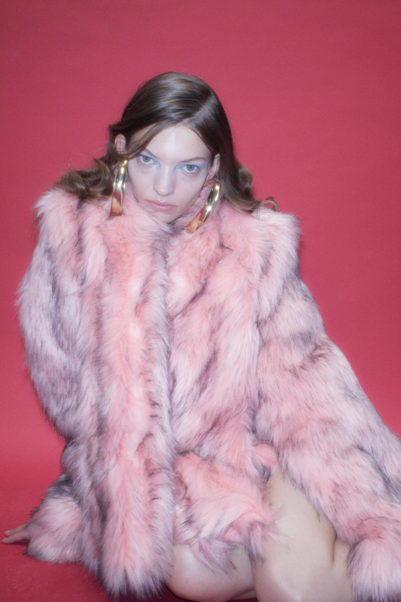 Sudi Etuz faux fur coat with attached scarf, showcasing a plush, cozy winter jacket with a stylish design and soft fur texture.