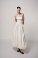 Ivory Whisper gown by TONYY, elegant evening dress with flowing fabric and delicate details, perfect for formal occasions.