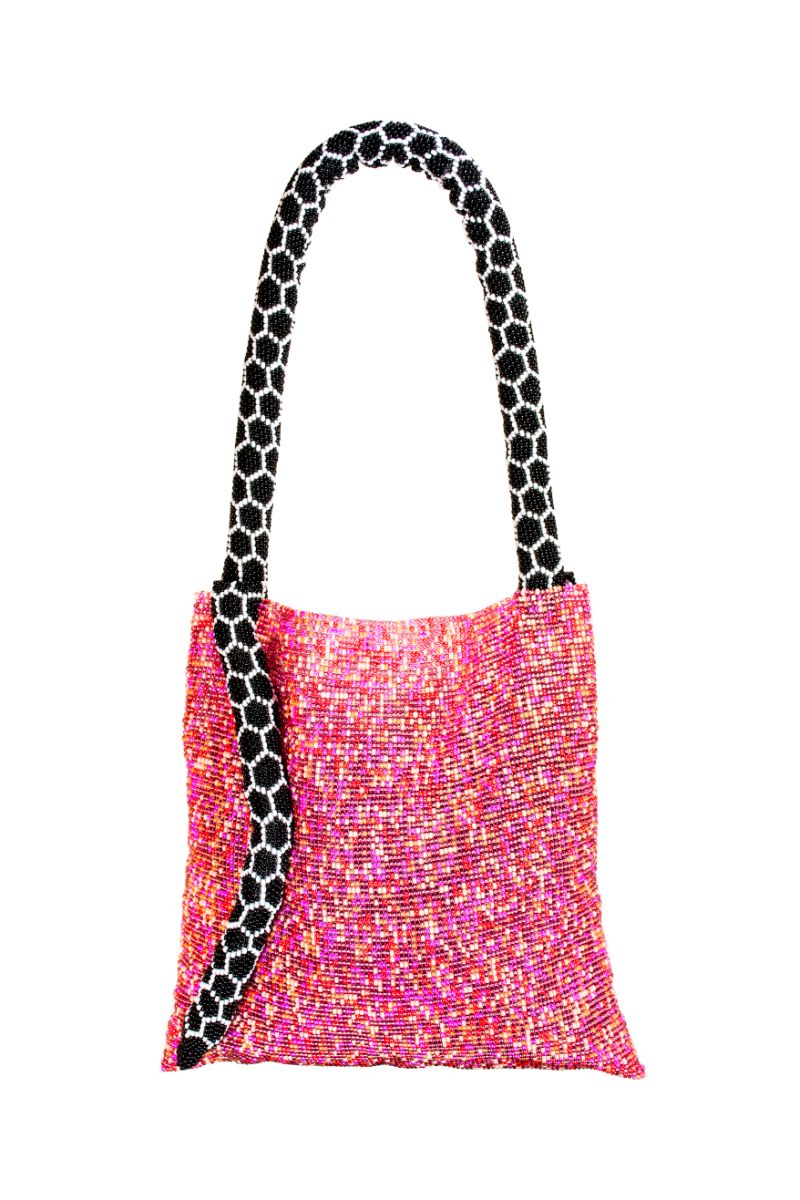 Small pink Serpent shoulder bag by SAC DE SOUL with black and white accents, featuring a textured serpent pattern and sleek design.