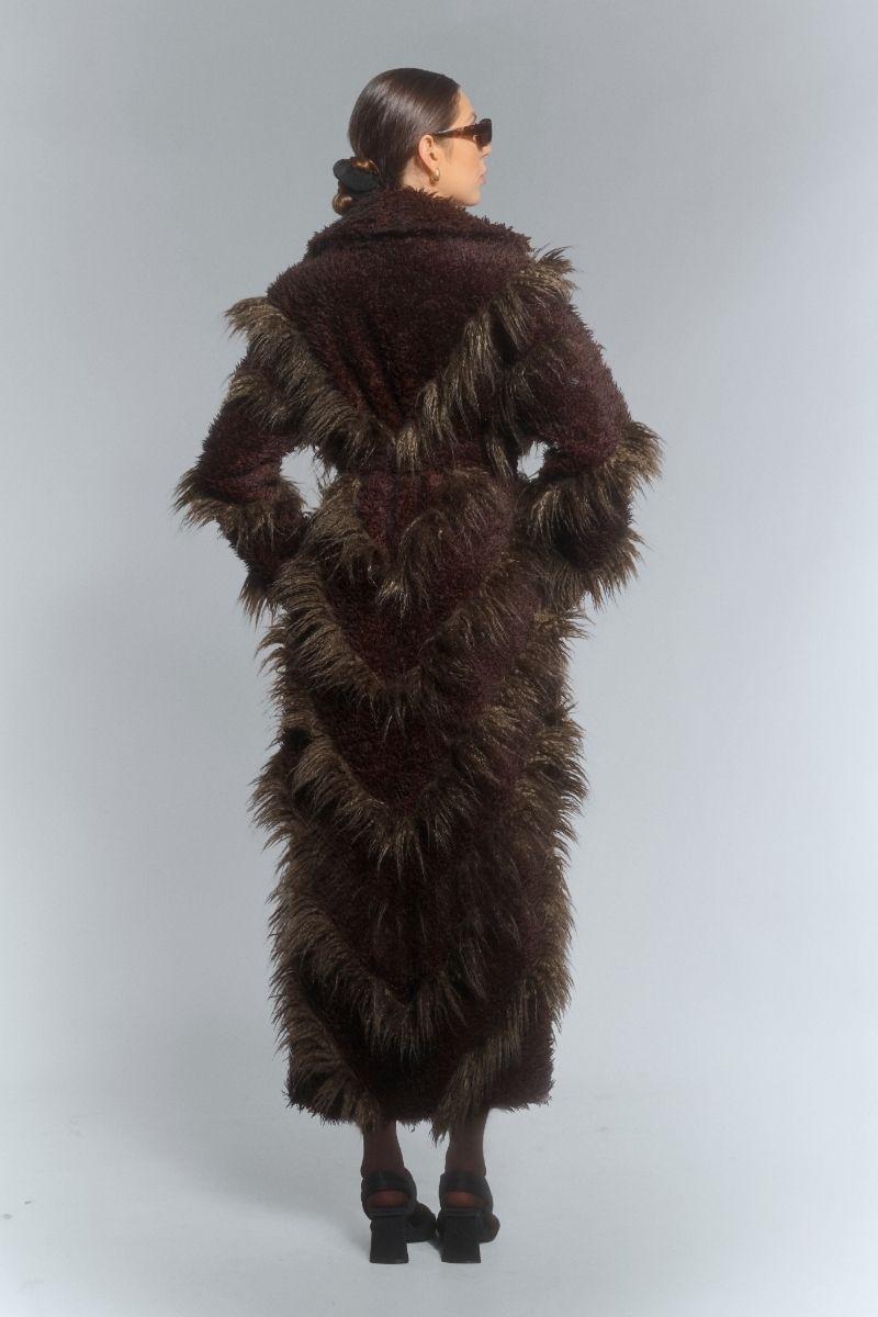 Brown faux fur maxi coat with diagonal panel design by Fortini, showcasing plush texture and stylish, oversized silhouette.