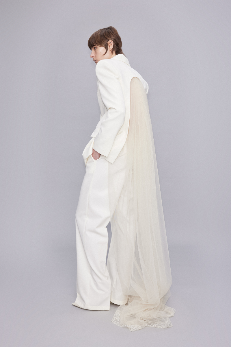 Sudi Etuz blazer with full-length tulle train at the back, stylish tailored jacket with elegant flowing tulle detail.