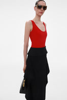 ELENAREVA red jersey bodysuit, close-up of sleek, fitted top with scoop neckline and smooth fabric detail.