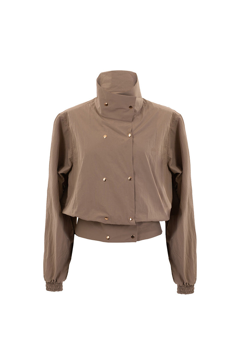 Beige Kris Marán bomber jacket with high neck, stylish and warm, featuring modern design and comfortable fit.