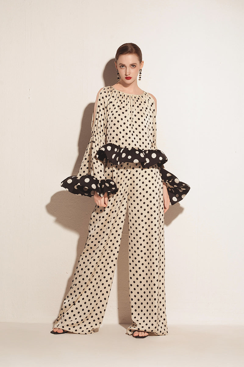 Cream Valenciani voluminuous ruffle sleeve top with puffed sleeves and feminine design, shown on a model.