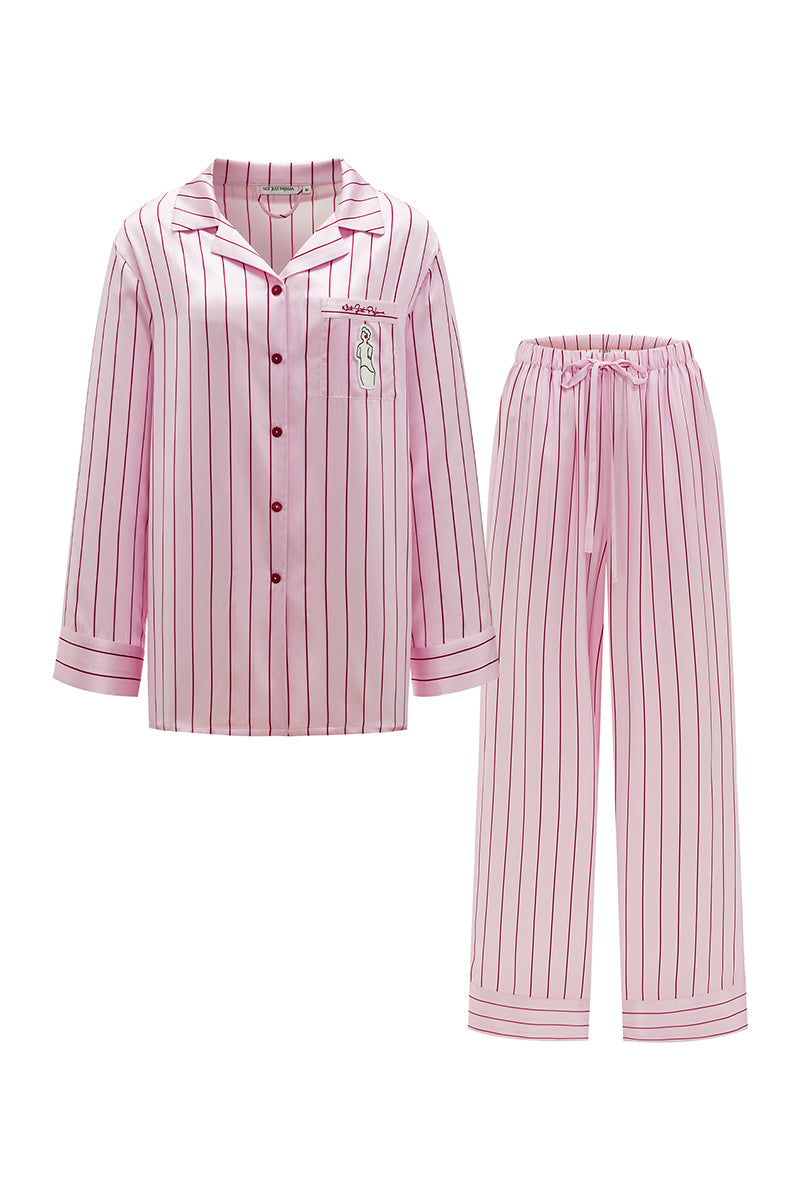 Pink striped silk pajama set from Not Just Pajama's Museum of Crush collection, featuring a long sleeve top and matching pants.