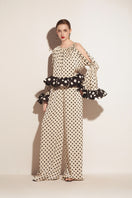 Cream Valenciani ruffle sleeve top with voluminous sleeves and feminine design, shown on a model.