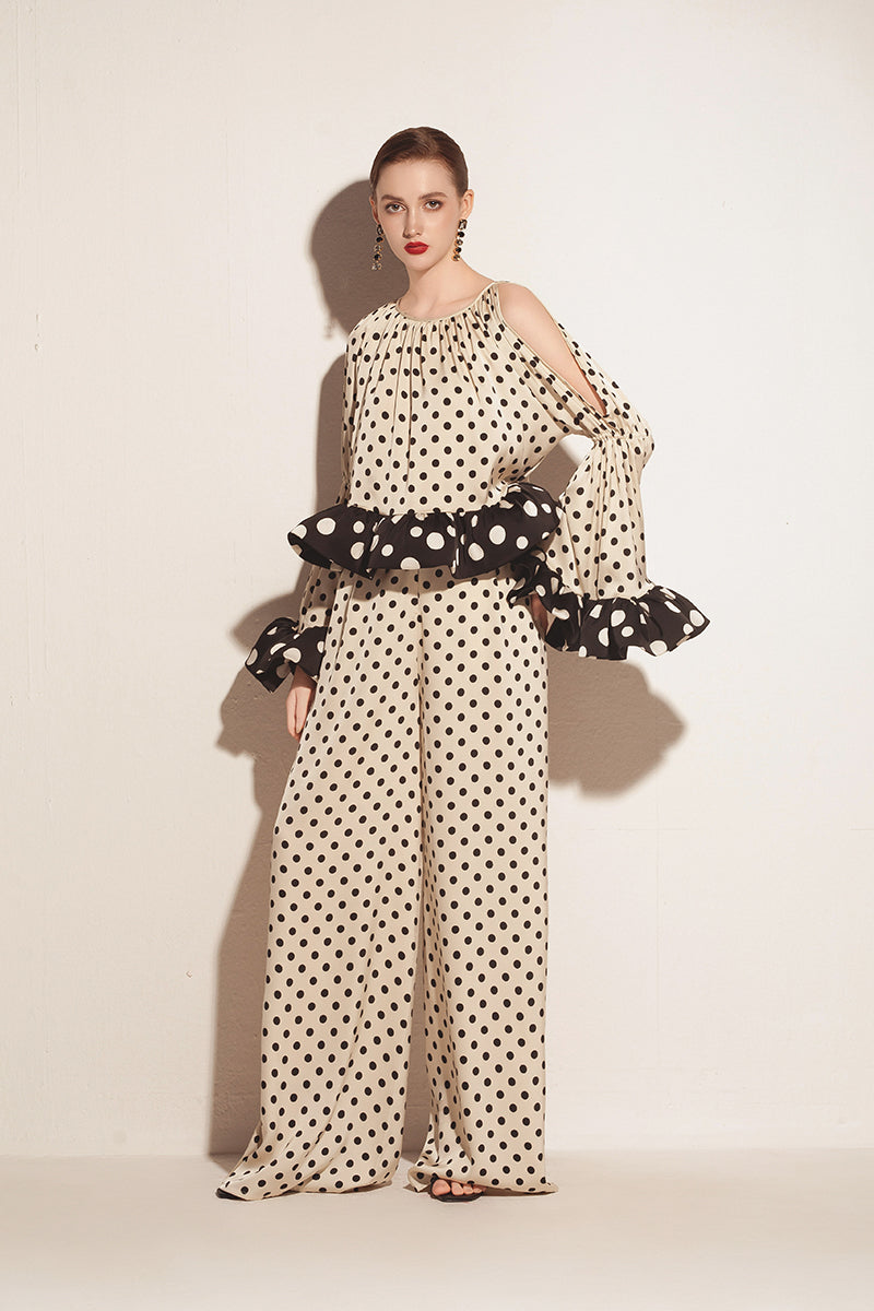 Cream Valenciani ruffle sleeve top with voluminous sleeves and feminine design, shown on a model.