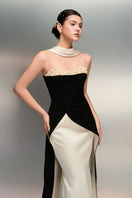 Black and white Lulwa crepe and silk taffeta gown by 21Six, featuring elegant draping and a sophisticated silhouette.