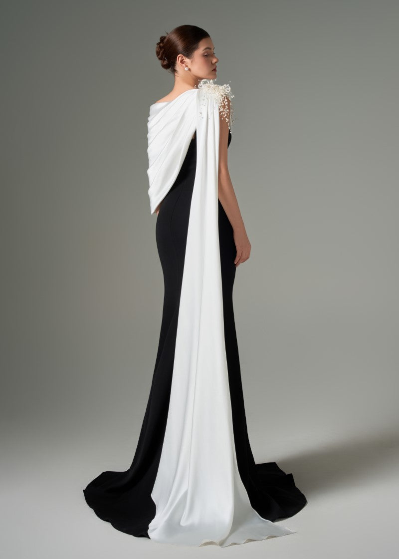 Negin crepe and silk fishtail gown by 21Six featuring elegant draping and a fitted silhouette, displayed on a mannequin.