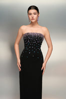 Black Maha Crepe dress by 21Six, elegant gown with a flowing silhouette and subtle detailing, suitable for formal occasions.