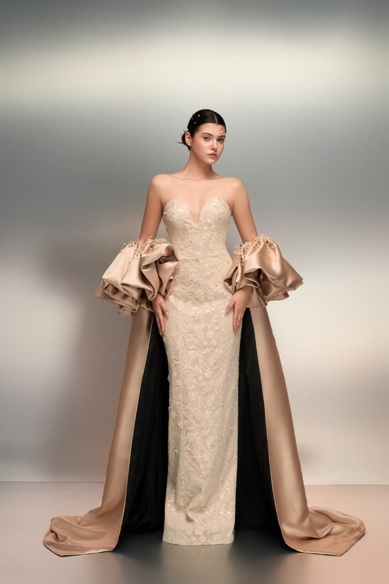Beige lace gown by 21Six featuring intricate lace details and a flowing silhouette, perfect for elegant occasions.