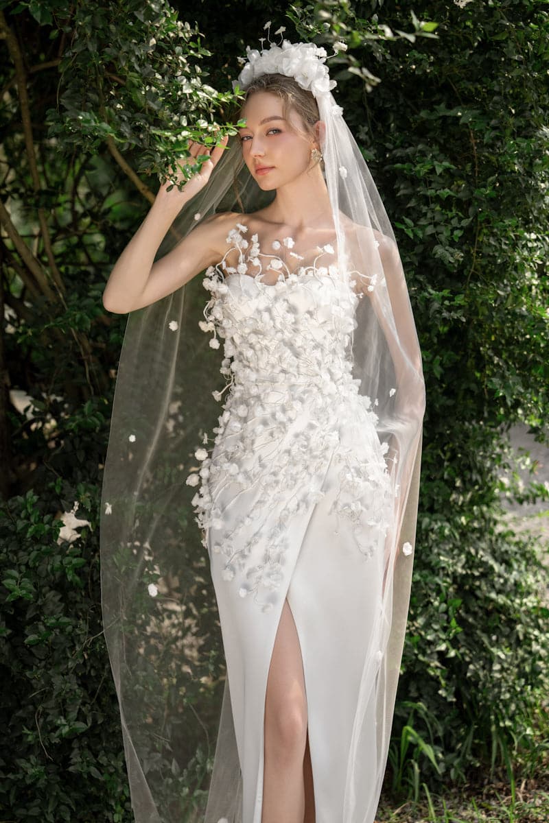 Elegant satin gown by 21Six with silk flower embellishments, featuring a flowing silhouette and intricate detailing.